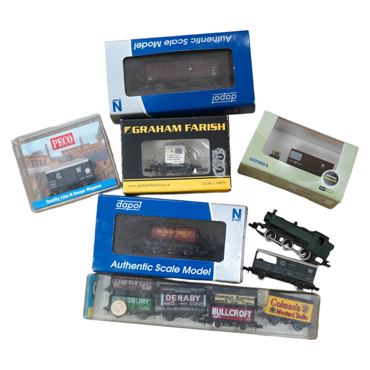 Twenty-six N gauge railway items by Dapol, Graham Farish, etc. including two locomotives, a GWR Class 94xx loco and a BR Class 08 diesel shunter, together with twenty-four freight wagons plus an Oxford Diecast Scammell M